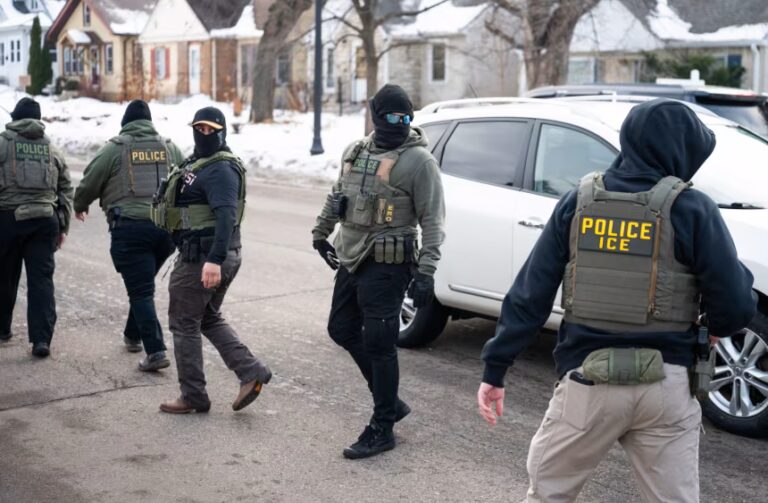 Federal agents leave a scene after one of their vehicles got a flat tire on Penn Avenue on February 5, in Minneapolis. Stephen Maturen/Getty Images